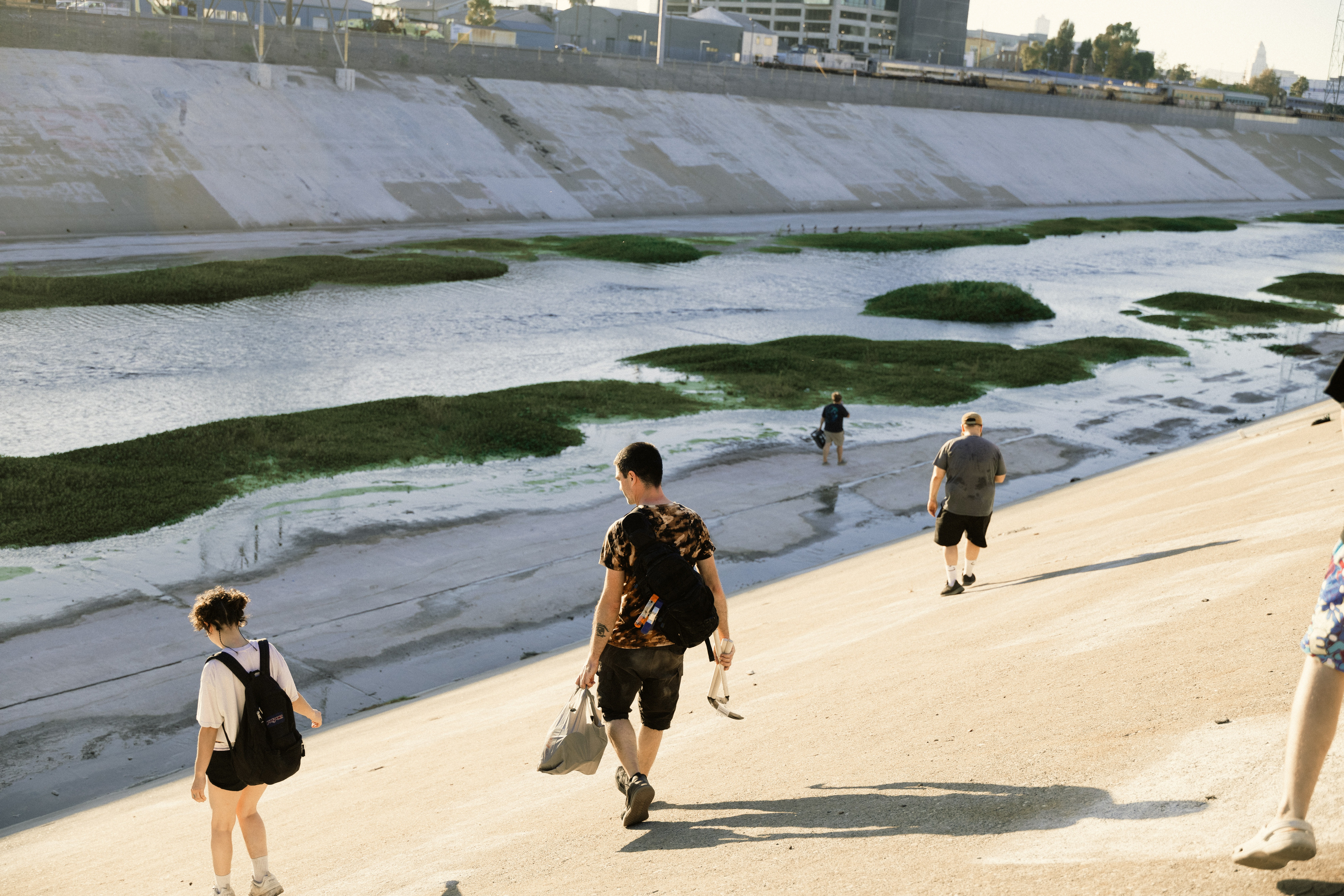 Artist Doug Rosenberg (center) leads a group of volunteers to his guerrilla wetland in the Los Angeles River.